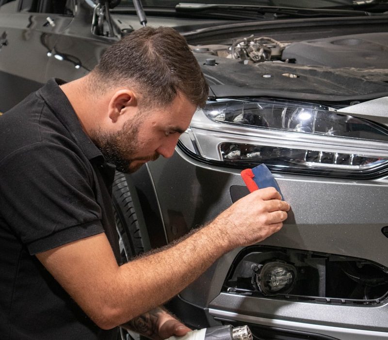 a man working on a car in a garage